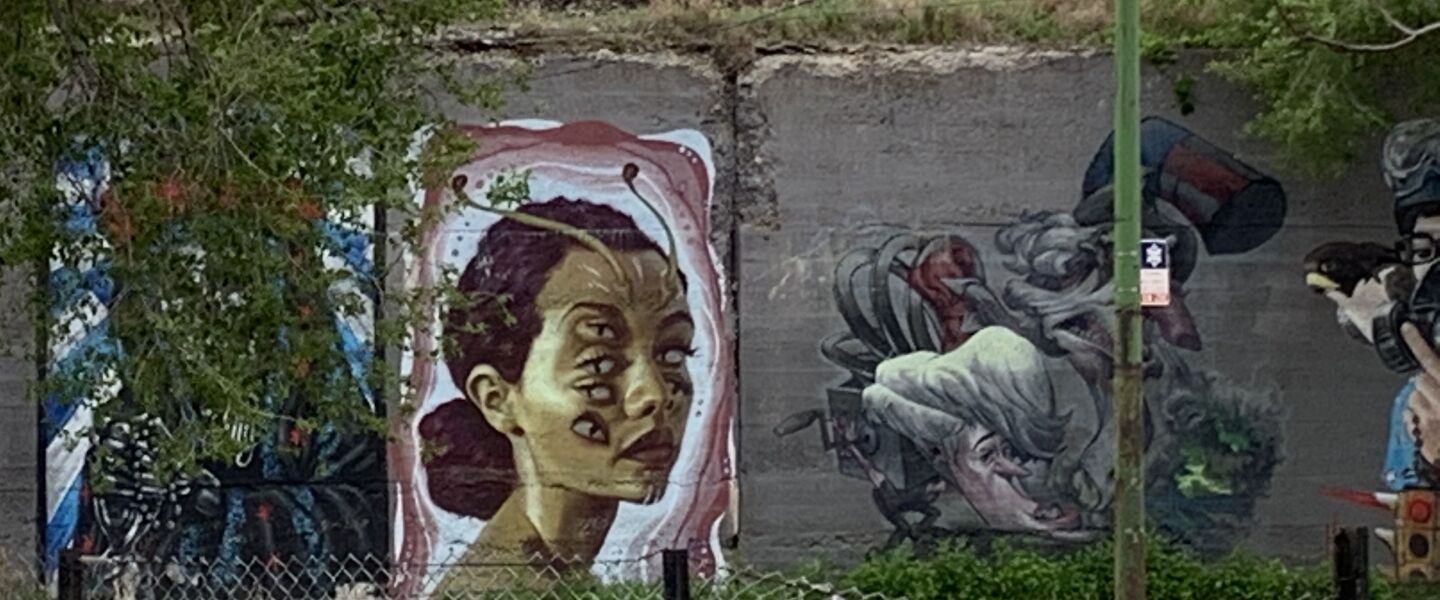 The mural of a multi-eyed woman was by an artist who goes by Diosa, who says: “My work is about perception, looking deeper, looking beyond, questioning reality, attuning yourself to appreciate the magic that bubbles beneath the surface of everyday life. I believe that ‘how we see determines what we see.’ So my approach to life and art-making is to constantly push myself . . . to look at things differently and to encourage my audience to do the same.”