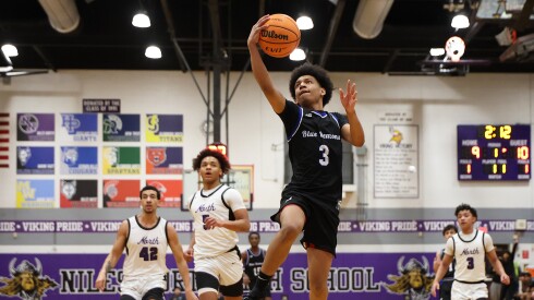 Maine East's Jayden Dozie (3) gets open for an easy two early in the Blue Demons 65-63 victory over Niles North.