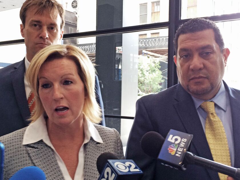 Shannon Spalding and Daniel Echeverria address reporters in the lobby of the federal courthouse after announcing they had settled their “code of<br>silence” lawsuit against the city for $2 million. | Andy Grimm/Sun-Times