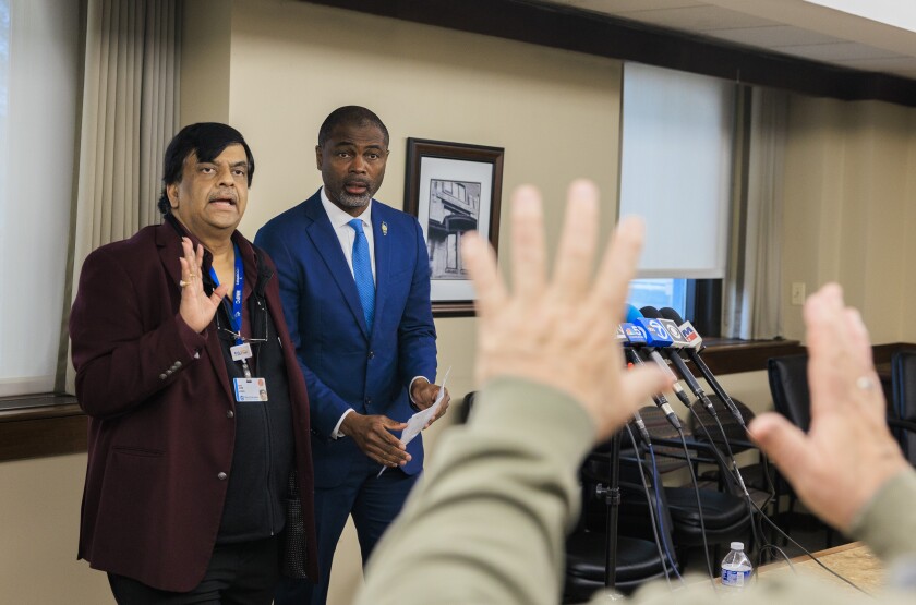 A reporter puts his hands up Wednesday as he asks questions to Resilience Healthcare CEO Manoj Prasad and State Rep. La Shawn K. Ford about the future of West Suburban Medical Center in Oak Park.