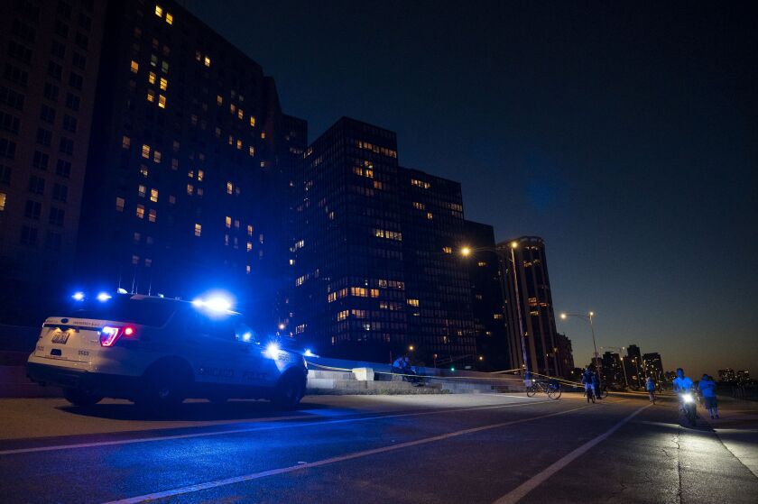 Chicago police work the scene Monday evening after a person was shot on the Lakefront Trail near the 800 block of North Lake Shore Drive in the Gold Coast neighborhood.