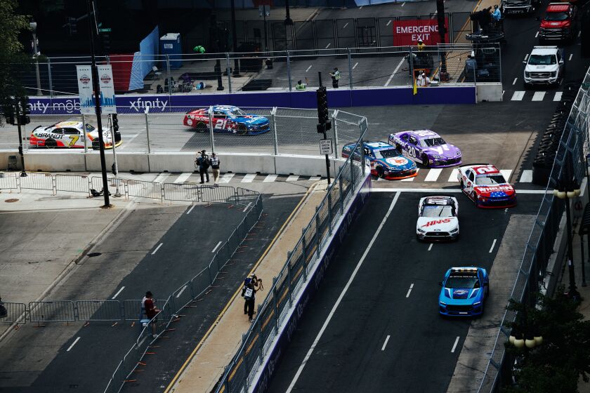 Cars race down Michigan Ave during NASCAR’s first street race in downtown, on Saturday, July 1, 2023.