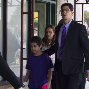 Lidia Souza, her nine-year-old son Diogo and their attorneys walk out of the office of Heartland Alliance in Chicago. | Pat Nabong/For the Sun-Times