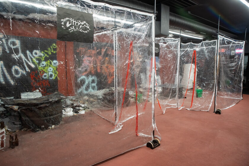 Three rage rooms are separated by plastic dividers at Breaking Point Rage Room.