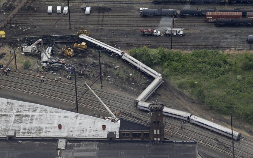 <small>Emergency personnel work at the scene of a deadly train derailment, Wednesday, May 13, 2015, in Philadelphia. | Patrick Semansky/AP</small>
