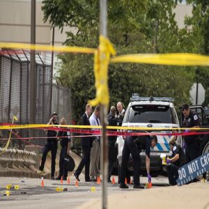Chicago Police investigate at the 25th District station, 5555 W. Grand Ave., on the Northwest Side, after multiple officers were shot outside the station, Thursday morning, July 30, 2020. The suspect was also shot multiple times in the incident.