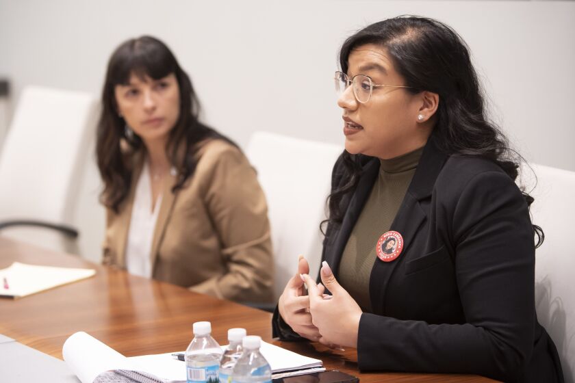 State Rep. Eva-Dina Delgado, left, listens as challenger Nidia Carranza speaks during a meeting with the Sun-Times Editorial Board last month. File Photo
