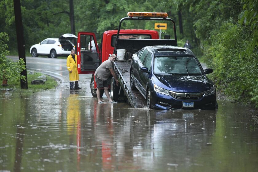 A car is being towed off of Ruxton Road in Towson, Md., Sunday, May 27, 2018. Flash flooding and water rescues are being reported in Maryland as heavy rain soaks much of the state. | Jerry Jackson/The Baltimore Sun via AP