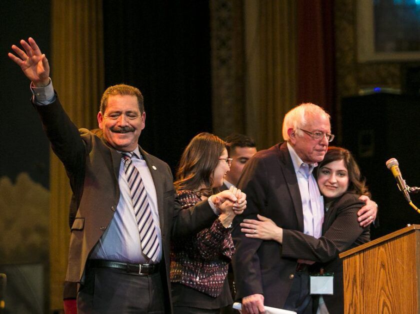 (From left to right) Cook County Commissioner Jesus “Chuy” Garcia, Alma Anaya, candidate for Cook County Commissioner, U.S. Sen. Bernie Sanders and Delia Ramirez, candidate for Illinois sate representative, wave to the crowd after Sanders headlined a camp