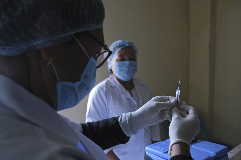 A nurse prepares a syringe with COVID-19 vaccine at District Hospital in Ukhrul, in the northeastern Indian state of Manipur on Saturday.