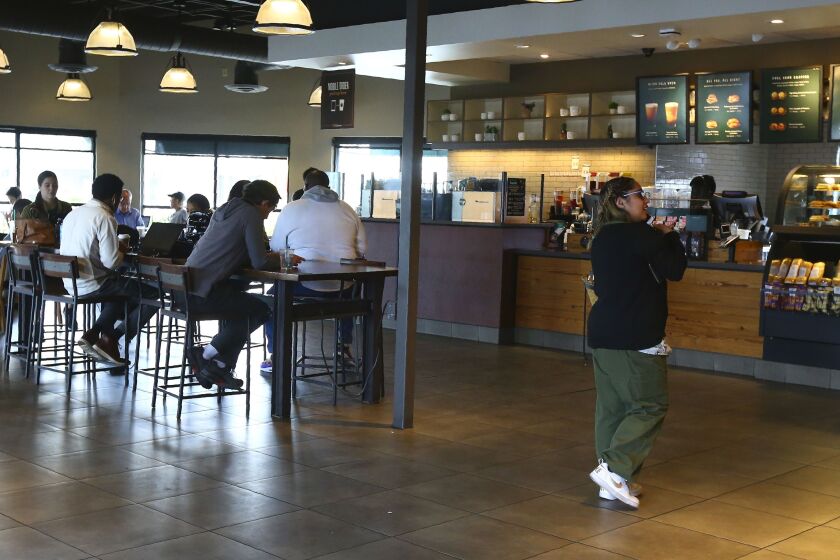 A local Starbucks Community Store, in Phoenix, Arisona. The larger Starbucks location has a community meeting space for events and programming, and offers local community hiring.