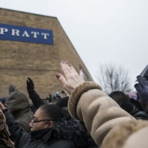 Mourners extend their hands in prayer at a vigil for the five people killed two days earlier in a mass shooting at the Henry Pratt Company in Aurora, Sunday afternoon, Feb. 17, 2019. | Ashlee Rezin/Sun-Times