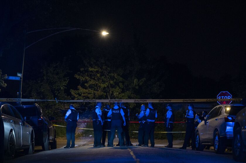Chicago police work the scene where 4 people were shot in the 8900 block of South Carpenter Street, in the Gresham neighborhood, Saturday, July 3, 2021.