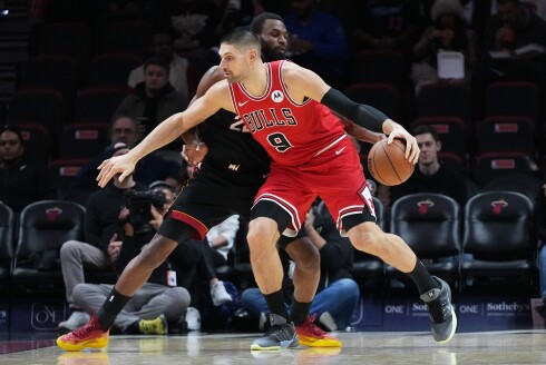 Bulls center Nikola Vucevic controls the ball as Miami Heat forward Andrew Wiggins, left, defends during the first half of a game on Sunday, Feb. 1, 2026, in Miami.