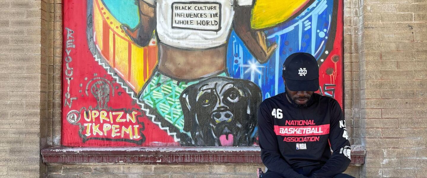 The dog at the bottom of this mural by Uprizn Ikpemi at 63rd Street and Racine Avenue is the artist’s bullmastiff Peppo.