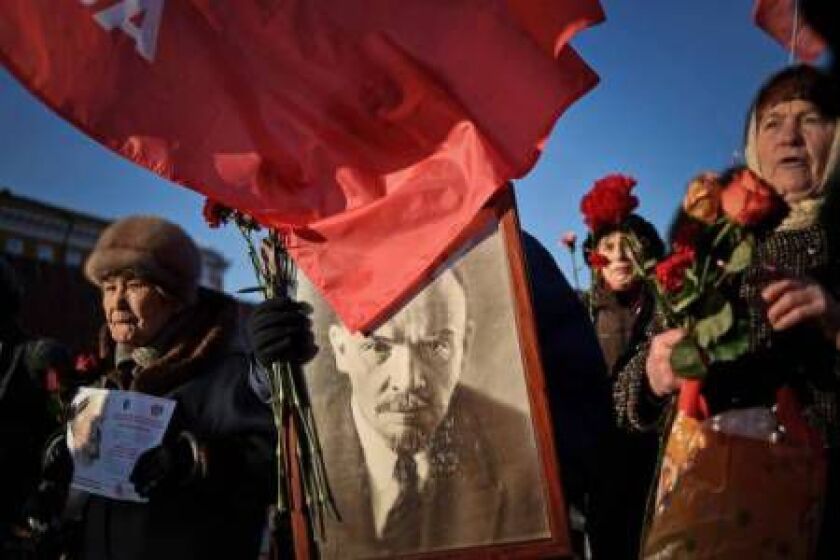 Russian Communist Party supporters carry a portrait of late Soviet leader Vladimir Lenin as they take part in a memorial ceremony to mark the 91st anniversary of his death at Red Square in central Moscow on January 21, 2015. KIRILL KUDRYAVTSEV/AFP/Getty I
