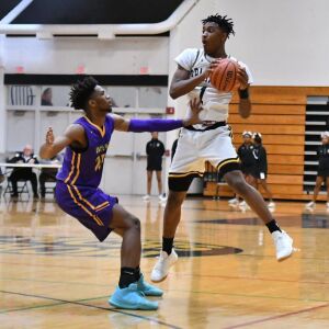 Waukegan’s Bryant Brown (25) hits Marian Catholic’s Ahron Ulis (1). Worsom Robinson/For the Sun-Times.