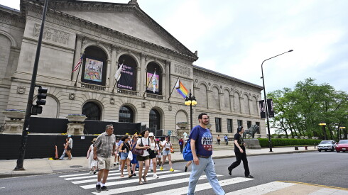 A group of people on a walking tour cross the street.