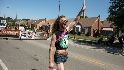 Starbucks shift supervisor J. Alan marches along Ewing Avenue in the East Side neighborhood on Saturday during the Chicago Labor Day Parade.