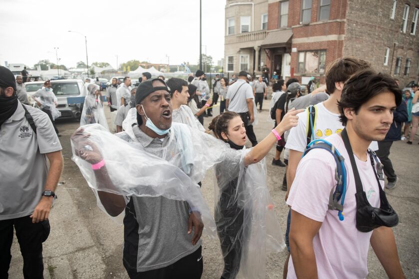Security urges Spring Awakening Musical Festival: Autumn Equinox festival goers to evacuate due to severe weather near the Addams/Medill Park in the University Village neighborhood, Saturday afternoon, October 2, 2021.