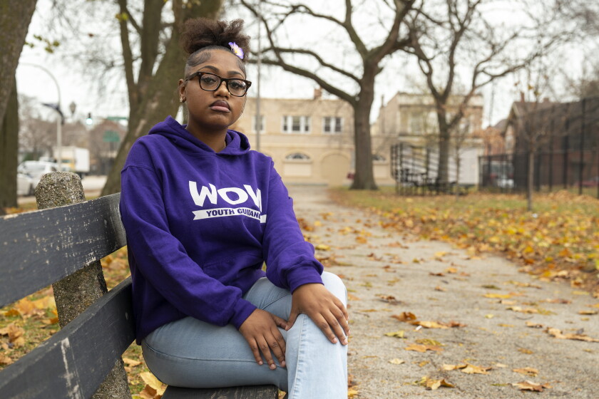 Maniya Franklin, an alumnus of the Working on Womanhood program, sits on a bench in Russell Square Park, Wednesday, Nov. 19, 2025. 