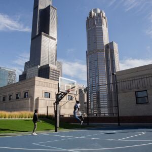 Christian King, left, and Caleb, sons of Uber driver Isaac King III, play basketball on Uber’s rooftop during the grand opening of Uber’s office at the old post office in South Loop, Tuesday morning, October 19, 2021. | Pat Nabong/Sun-Times
