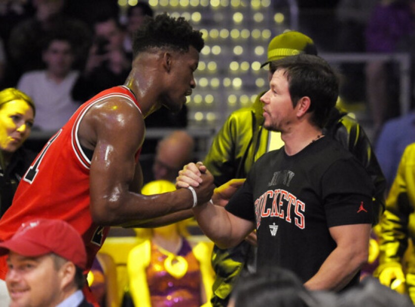 Jimmy Butler greets friend Mark Wahlberg in January at the Lakers game in Los Angeles. | AP