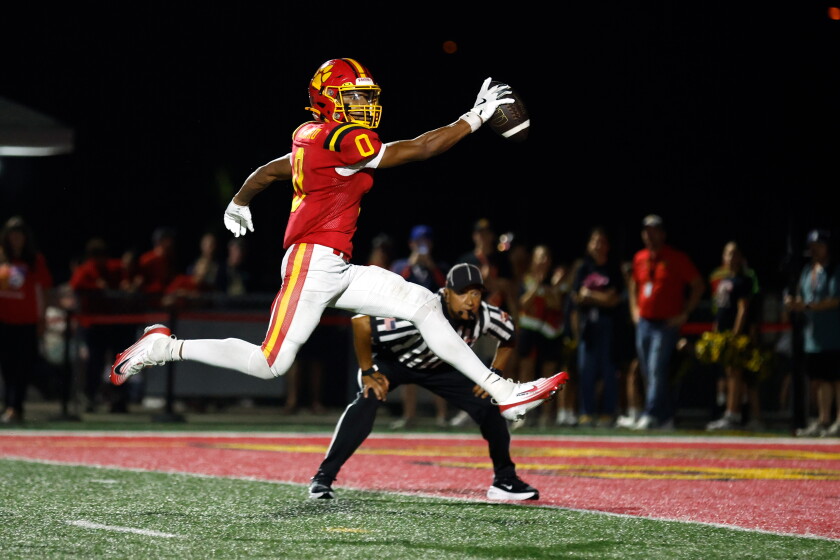 Batavia's Darin Ashiru (0) leaps into the end zone for a touchdown against Maine South.