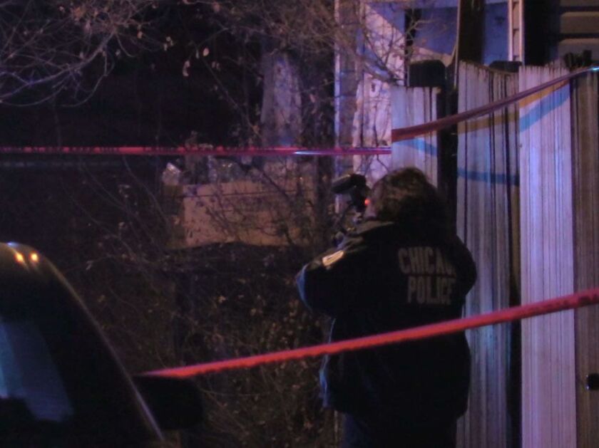 Police investigate the fatal shooting of 2 people Wednesday evening in the 6600 block of South Oakley Avenue.| Justin Jackson/Sun-Times