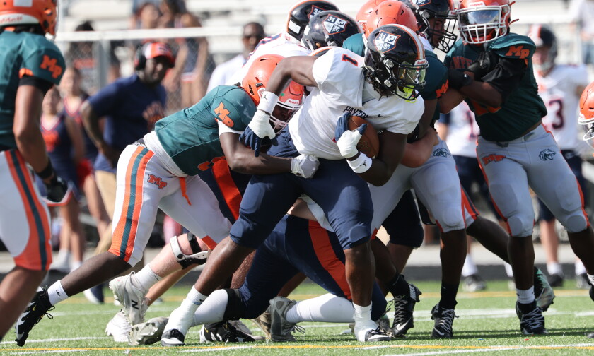 Payton's Kobe Ferguson (1) fights for some tough yards against Morgan Park.