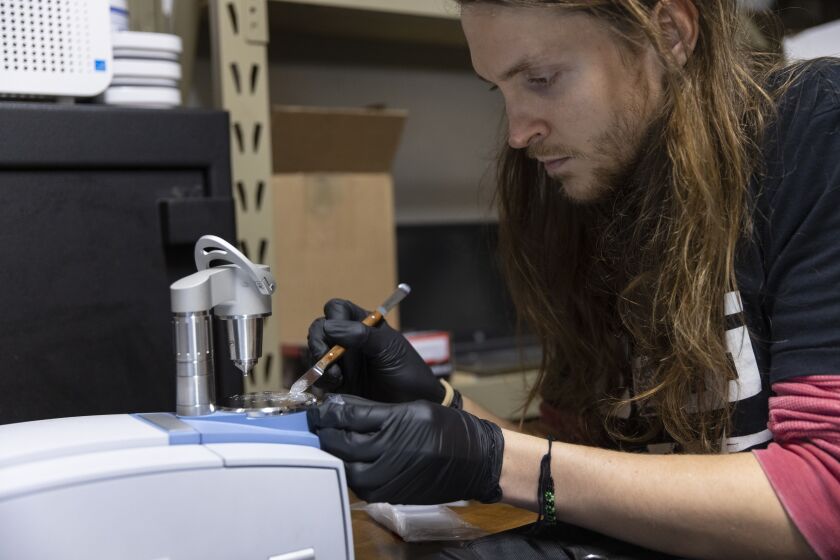 Taylor Wood examines a test sample of methamphetamine at the Chicago Recovery Alliance, 3110 W. Taylor St. on the Near West Side.