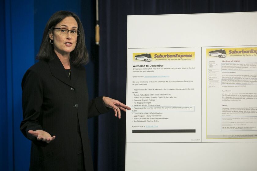 At a news conference Monday detailing a lawsuit against Suburban Express, a bus company offering service to several regional universities, Illinois Attorney General Lisa Madigan displayed printouts from the firm’s website that included offensive language