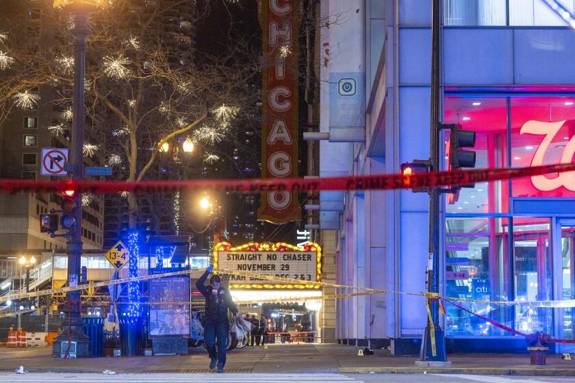 Chicago police investigate the scene where multiple people were shot outside the Chicago Theatre in the Loop, Friday, Nov. 21, 2025.