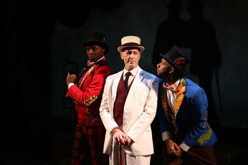 Denzel Tsopnang (from left) as Mr. Bones, Larry Yando as The Interlocutor, and Mark J.P. Hood as Mr. Tambo in the Porchlight Music Theatre production of “The Scottsboro Boys,” a Kander and Ebb musical. (Photo: Kelsey Jorissen)
