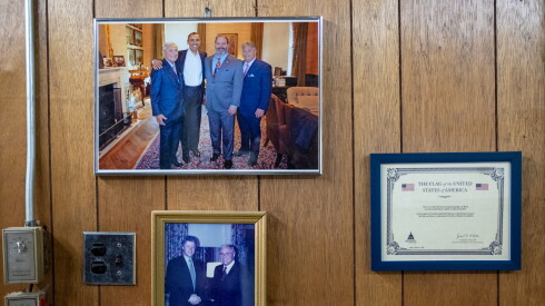 Photos of Martin Greenfield with Barack Obama and Bill Clinton hang on the wall at Martin Greenfield Clothiers in Brooklyn, New York.
