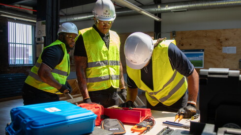 JIREH graduates Jonathan Franklin, Curtis Lawrence, Charles Doyle and Laquan Hawthorn demonstrate installing solar panels at the nonprofit's Near West Side training center.
