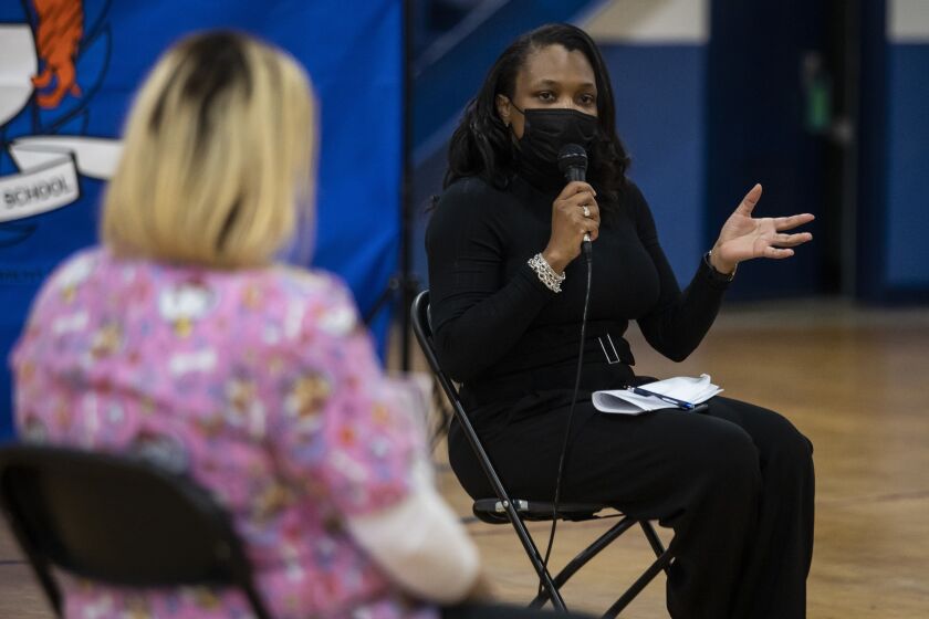Chicago Public Schools CEO Janice Jackson talks with parents Tuesday at Belmont-Cragin Elementary School on the Northwest Side.