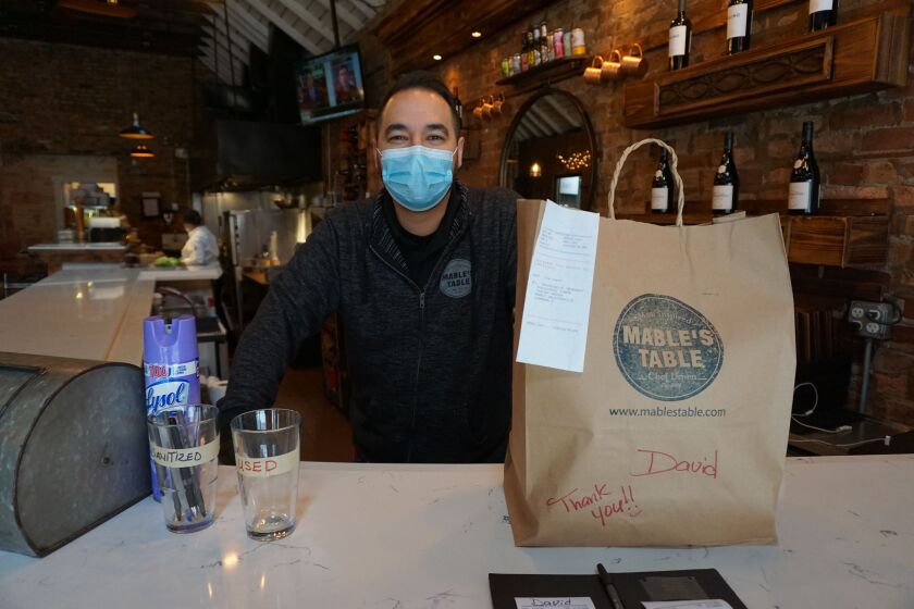 Mable’s Table chef/owner Anthony Reyes prepares an order for pickup at his Bucktown restaurant.