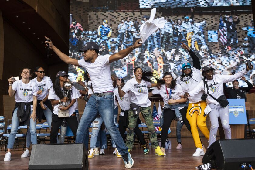 Chance the Rapper dances on stage with the Chicago Sky players.