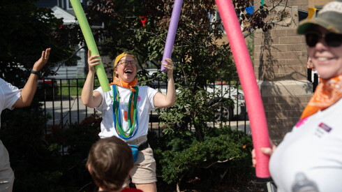 Hannah Mowrey, co-founder of Mobile Front Porch, shows kids how to play a game during “Field Day” at Hayt Elementary School in Edgewater.
