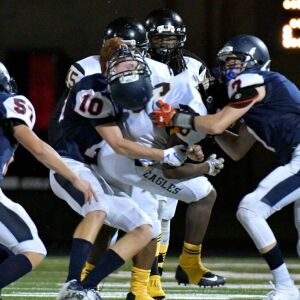 Payton’s Julian Melchor (10) gets his helmet knocked off. Worsom Robinson/For the Sun-Times.