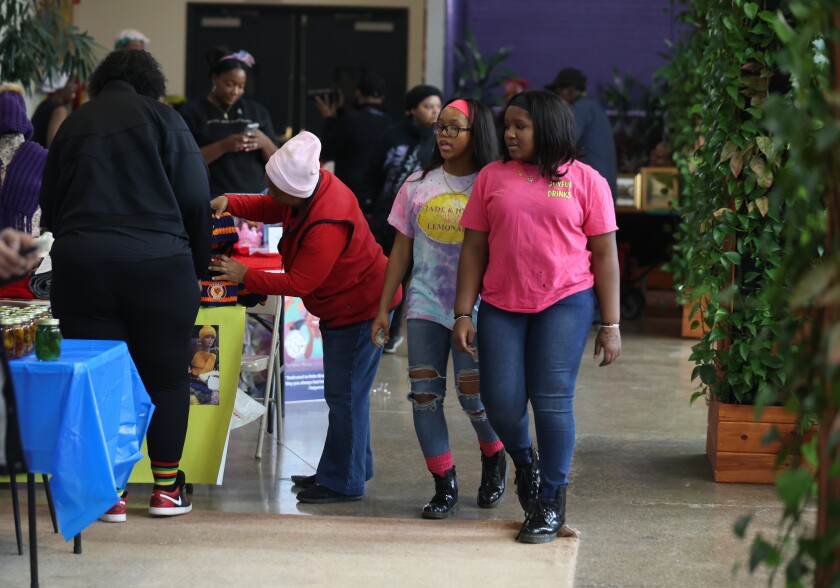 Siblings Jade Lee and Joy Lee (right), owners of Joyful walk around during a Kwanzaa celebration event at Hatch 41 in Chicago’s Bronzeville neighborhood on Saturday, Dec. 27, 2025.