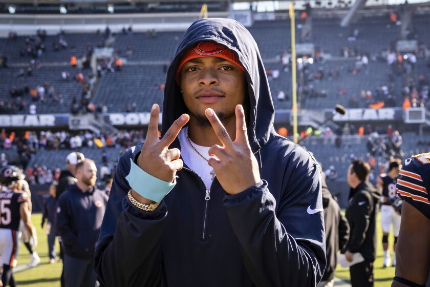 Chicago Bears quarterback Justin Fields gestures to the camera.