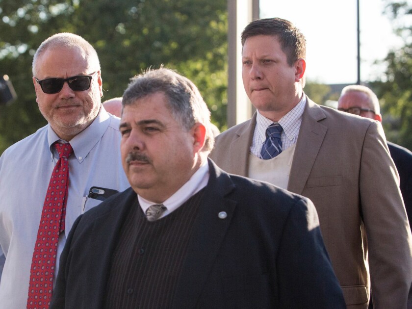 Chicago Police Officer Jason Van Dyke, in the tan suit coat over a bulletproof vest, is escorted into the Leighton Criminal Courthouse by Martin Preib, vice president of the Fraternal Order of Police (left), and FOP President Kevin Graham. | Ashlee Rezin/