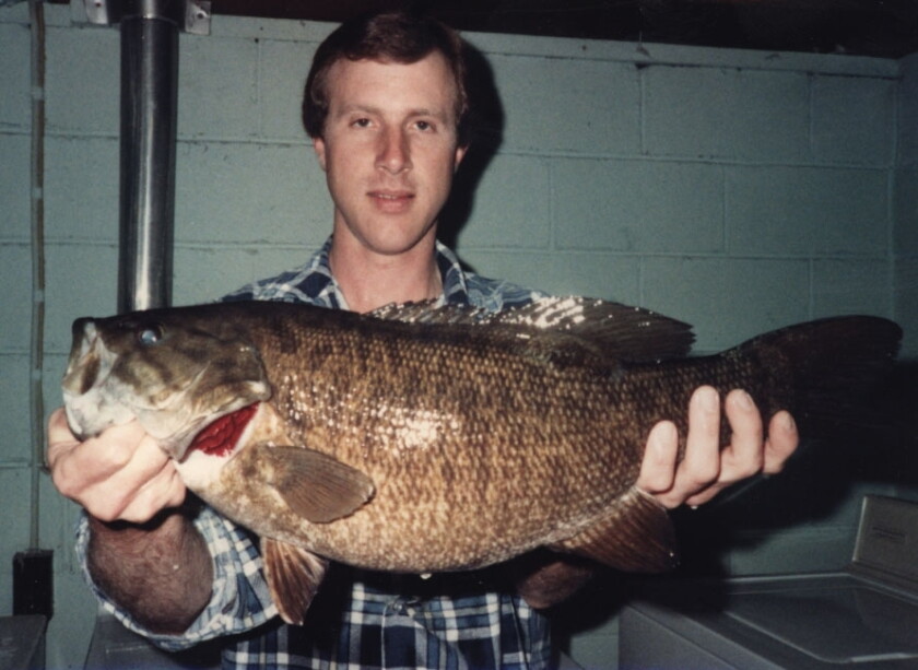 Mark Samp holds his smallmouth bass, which stood was the Illinois record from 1985 until 2019.