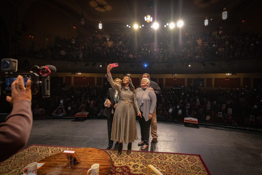 Shonda Rhimes takes a selfie on stage