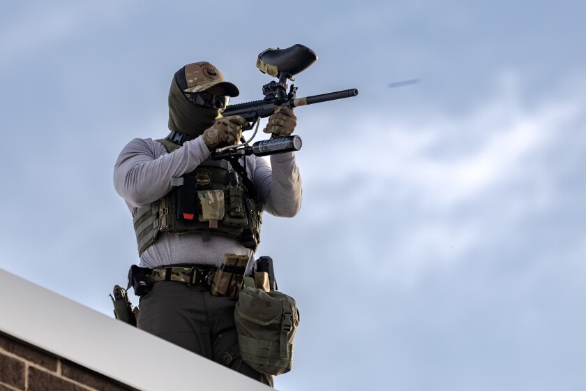A federal agent fires pepper balls at protesters from the rooftop of the Broadview ICE detainment facility on Sunday September 21, 2024. | Jim Vondruska/For the Sun-Times