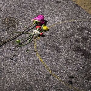 Mourners and protesters places flowers and other momentos near a blood stain at the corner of 63rd Street and Sheridan Road, where a person was shot by an alleged vigilante on the fourth day of civil unrest after police shot Jacob Blake, Wednesday night, Aug. 26, 2020. Two people were killed and one person was shot and wounded during unrest Tuesday night and Kyle Rittenhouse, 17, has been charged in connection with the shootings.