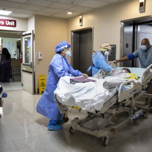 A patient is wheeled out of the Intensive Care Unit at Roseland Community Hospital on the Far South Side, Tuesday afternoon, Dec. 8, 2020.