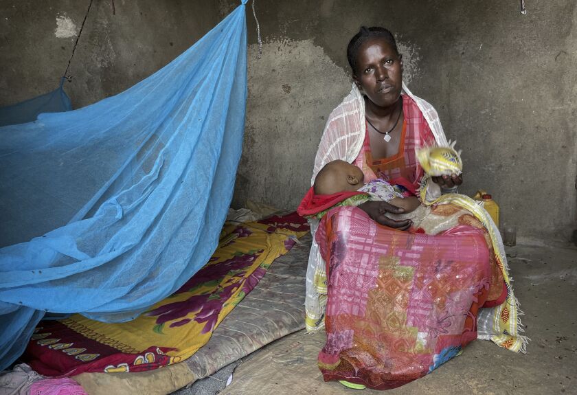 Letemariam, a mother of six, with her baby, who was born in a former camp for Eritrean refugees now used by internally displaced Tigrayans, after escaping fighting in her home town in western Tigray. Letemariam was seven months pregnant when her village was attacked. She and her five children fled on foot with only the clothes on their backs.
